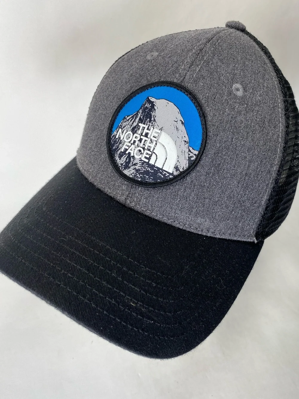 The North Face Grey & Black Patch Trucker Hat with Blue Accent Snap Back Unisex